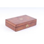 A small walnut veneer pistol box, the lid with vacant brass shield, blue baize lined fitted interior