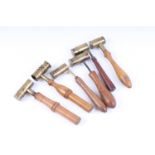 Six various brass adjustable powder measures with boxwood or fruitwood handles, one by Jas Dixon &