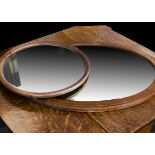 An Edwardian oval mirror, the bevel edged oval mirror with chequered strung decoration, 75cm x