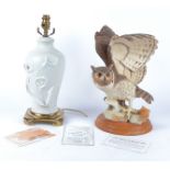 A Franklin Mint bisque porcelain sculpture of 'The Great Horned Owl', raised on a circular wooden