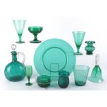 An emerald green glass decanter of bulbous form with clear twisted handled and multifaceted stopper,
