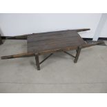 An antique stained pitch pine twin handled portable work top, with four rectangular supports and