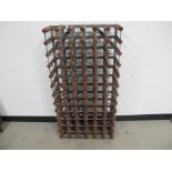 A seventy two bottle wooden and metal wine rack, 63cm x 24cm x 123cm