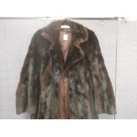 A ladies dark brown mink fur coat, with black suede panels, fitted waist with interior belt, brown