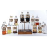 A collection of late 19th or early 20th Century pharmaceutical bottles, thirteen with original