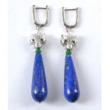 A pair of teardrop shaped lapis lazuli earrings, with panther's head terminals and green coloured