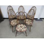 A set six Ercol Windsor Quaker chairs, five side and one carver, five with blue and gold stickers,