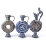 A group of seven German salt glaze stoneware ewers, probably Westerwald or Mettlach, the largest