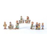 Eight Goebel Hummel figures of children, comprising 'Grandma's Girl' no.561, 'Little Sweeper' no.