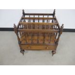 A 19th century rosewood Canterbury, three section with turned spindles, shaped top rails with turned