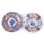 A pair of Oriental Imari design plates of floriform, both with central baskets of flowers and one