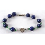 A bracelet with spherical lapis lazuli beads, with a panther's head and interspersed with