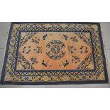 Four assorted small rugs, one on a peach ground with Oriental decoration, one on a beige ground with