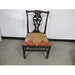 A 19th century mahogany Chippendale style chair, pierces splat back, shaped front rail, red and gold