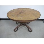 A 19th century oval table, veneered oak top supported on a bentwood base, believed to be a