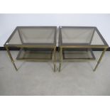 A pair of contemporary two tier occasional tables, glass tops and undershelves with brass metal
