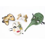 A contemporary plague mask, the papier Mache plague mask in green with elongated nose, together with