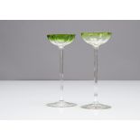 A pair of German Art Nouveau liquor glasses, the shallow quatrefoil green bowls on slender stems and