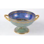 A Minton lustre twin handled comport with sponge effect and central decoration of fruits, height