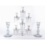Two 20th Century twin branch glass candelabra with lustre drops, each raised on a hexagonal base,