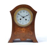 An Edwardian mantle clock, white enamel dial with Arabic numerals, indistinct writing on the dial '…