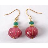 A pair of earrings with semi precious red stones similar to rubies, melon cut with mounted green