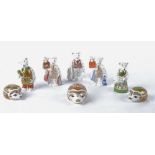 Eight Royal Crown Derby paperweights and figures, the three paperweights being hedgehogs with gold