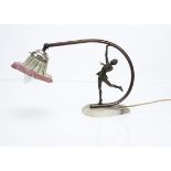 An Art Deco spelter, alabaster and iridescent glass table lamp, the figural table lamp in the