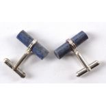 A pair of near cylindrical lapis lazuli mounted cufflinks, (pair)
