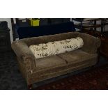 An Edwardian chesterfield sofa, with drop down end, the horse hair upholstered sofa with a patterned