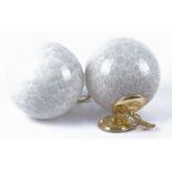A pair of glass globe lights, the glass with a grey marbled effect, with polished brass