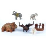 A selection of elephant models, wooden, metal and bone examples, including a cast iron plant stand