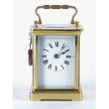 A 19th Century French carriage clock, White enamel dial with Roman numerals, in a polished brass and