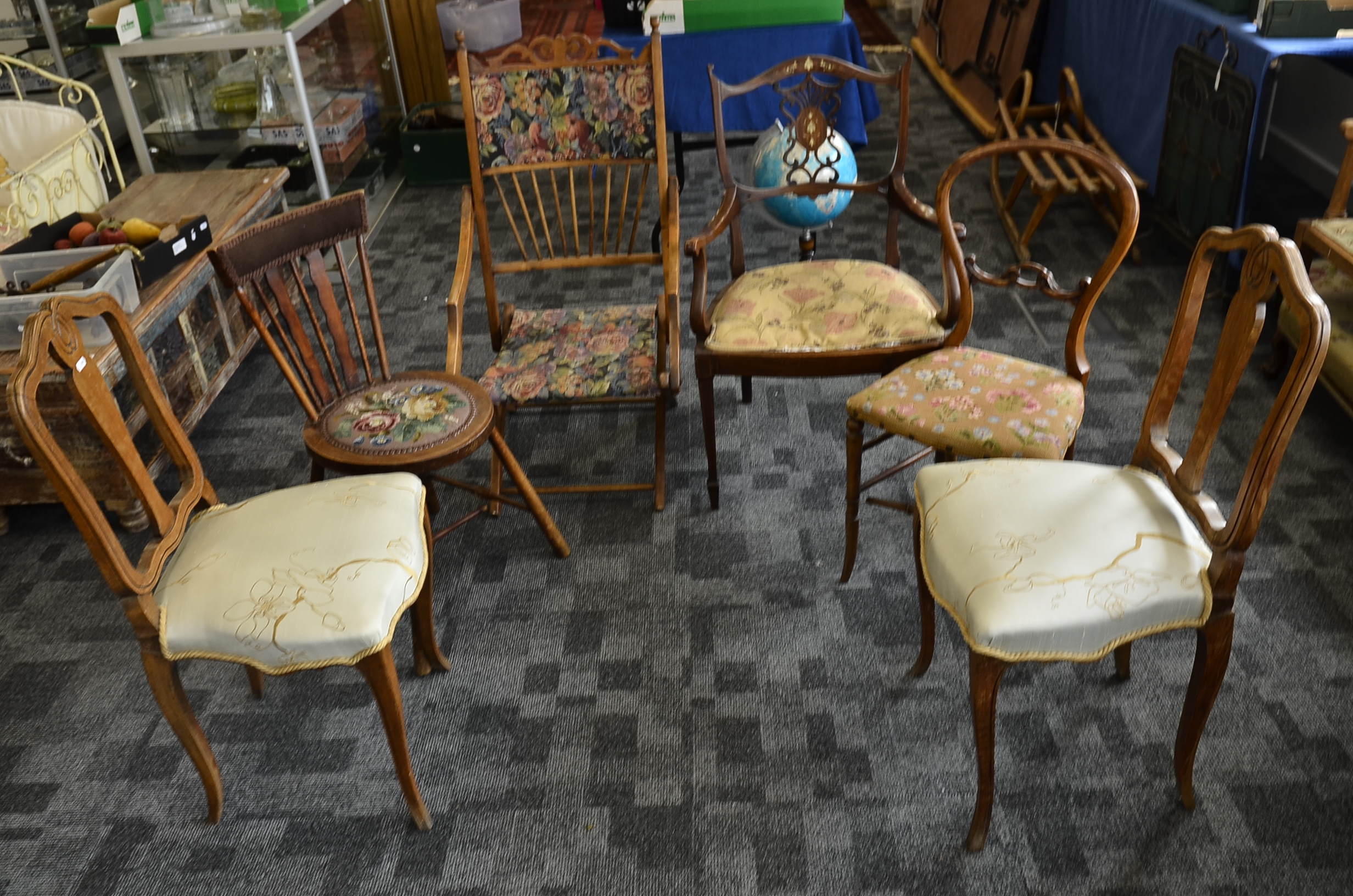 A collection of six various chairs, including an Edwardian inlaid armchair with stuff over seat