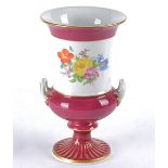 A late 19th Century Meissen twin handled campagna shaped urn with one central floral study and two