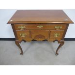 A late 19th century walnut low boy, moulded top, one long and three short drawers, shaped frieze,