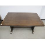 A Ercol style drawer leaf table, mahogany top, stained beech base with shaped end supports united by