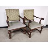 A pair of 'Boet' oak framed lounge chairs, with scroll arms, green upholstery (faded). Floor to
