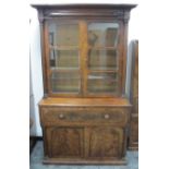 A 19th century figured mahogany secretary bookcase, the top section having a moulded cornice above a