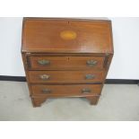 An Edwardian mahogany inlayed bureau fitted interior, three long drawers, raised on shape