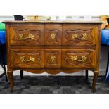 A continental walnut chest of drawers, the shaped moulded three panel section top over long drawer