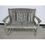 A weathered two seater teak garden bench, made by Listers, 114cm x 59cm x 86cm