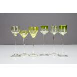 A set of three German Art Nouveau liquor glasses, the green tulip shaped bowls on a circular waisted