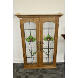 A contemporary oak and glazed panelled display cabinet, the glazed Art Nouveau lead lined panels