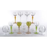A set of four continental hook glasses, with coloured stems and engraved decoration of grapes and