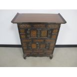 An oriental style hardwood side cabinet, three short drawers above two double doored cupboards faced