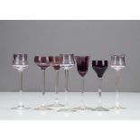 A set of three German Art Nouveau tulip shaped amethyst coloured liquor glasses, with amethyst bowls