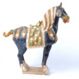 A large 20th Century Chinese sancai glazed statue of a horse after the Tang, a/f with loss to ear,