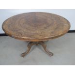 A Victorian burr walnut oval loo table, tilt top action supported on a bulbous reed column and a