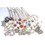 A collection of costume jewellery, pendants, charm bracelets, beaded bracelets, cufflinks, tie clips